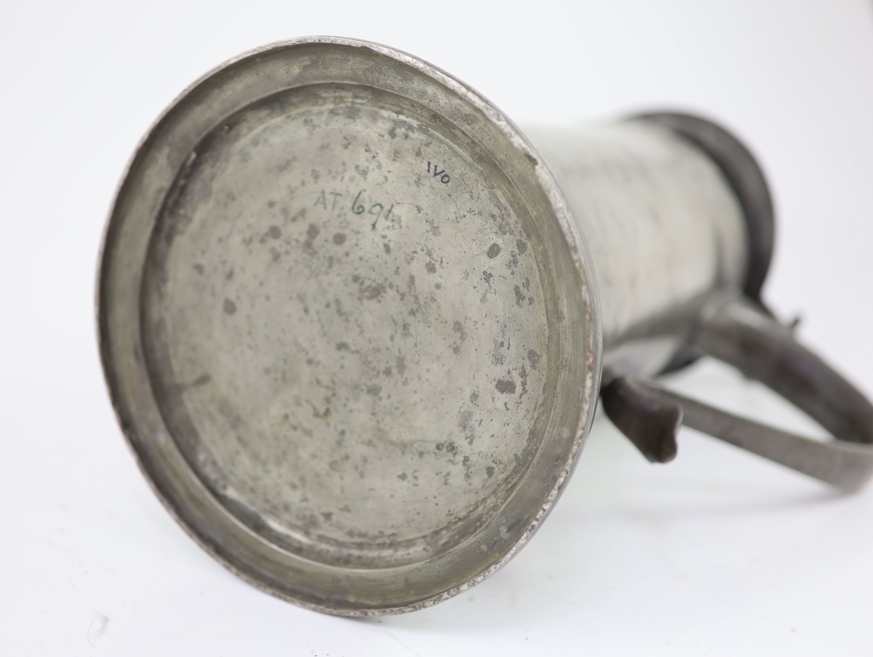 An early 17th century pewter flagon of large proportions H 34cm.